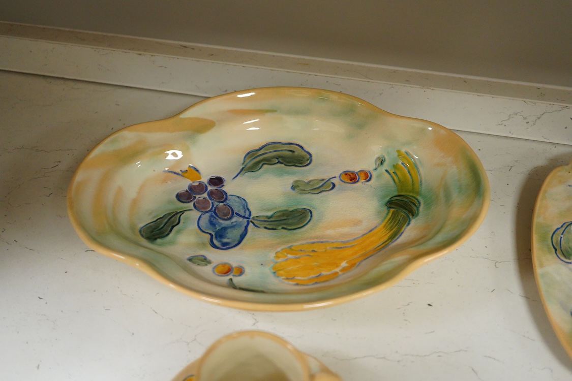 A collection of Doulton Brangwynware to include an oval dish, wall plate and two coffee cans and saucers, largest 32cm in diameter